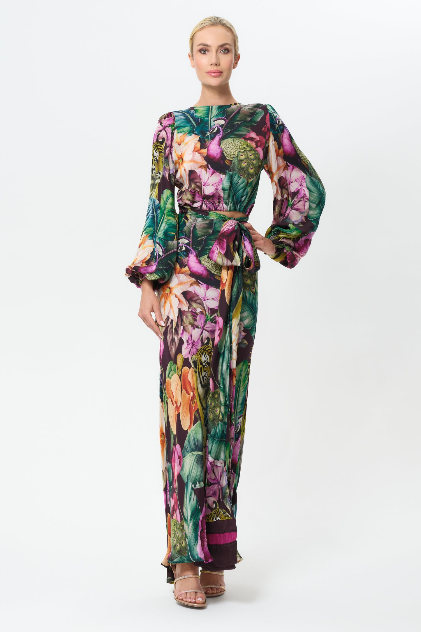 Woman wearing a colorful floral outfit on a white background