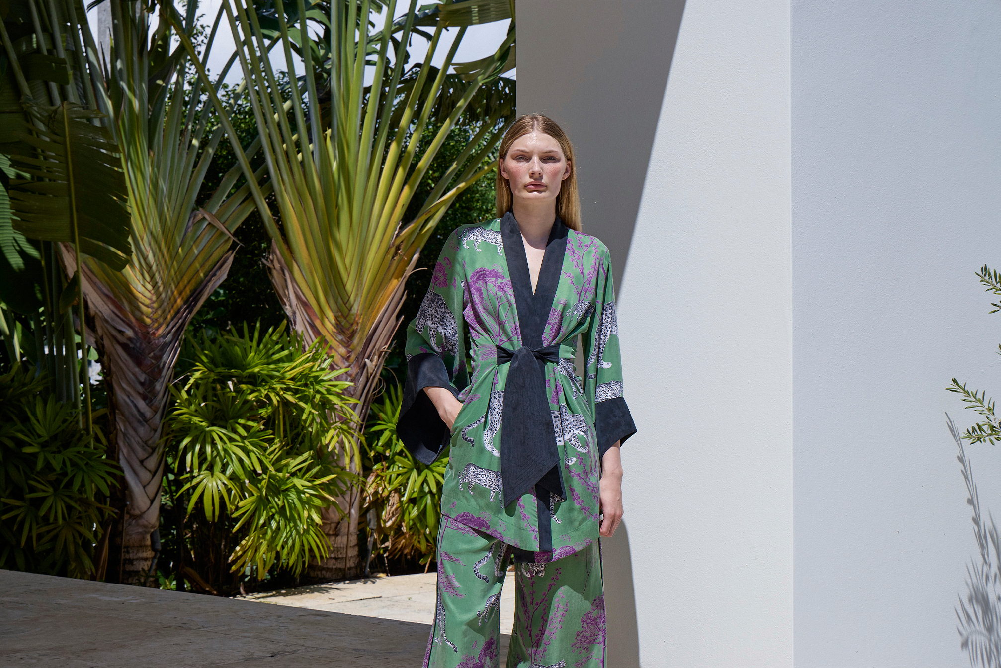 Model wearing Lennon Amara Kimono against white wall with foliage