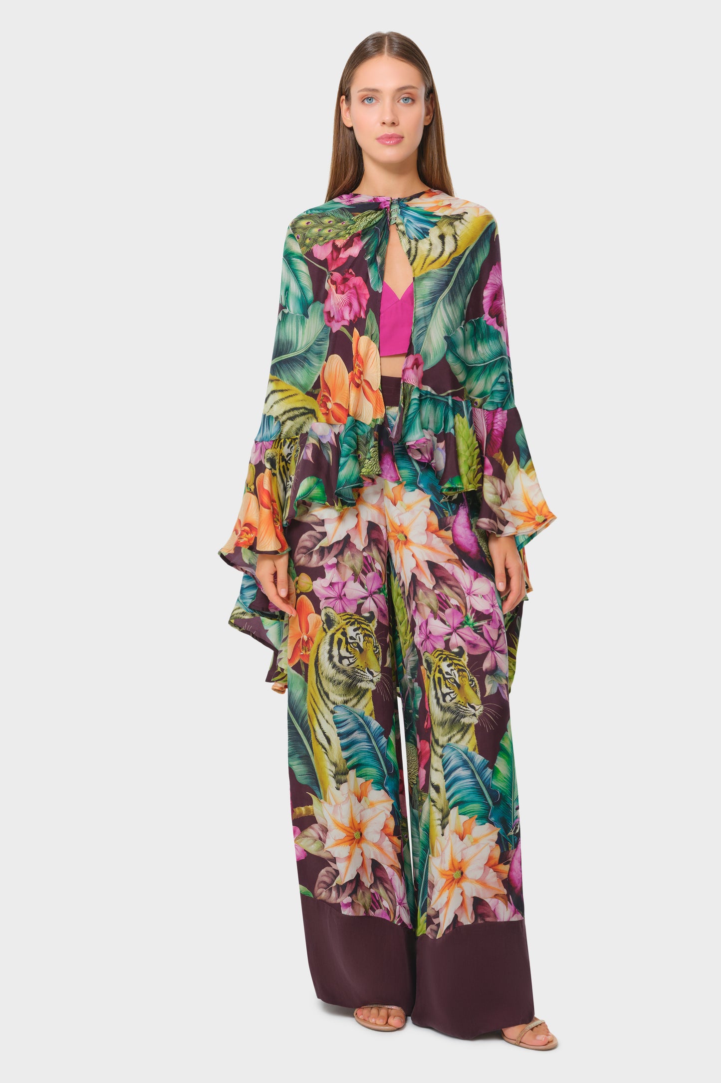 Model in multicolor printed cape-style top with matching long skirt