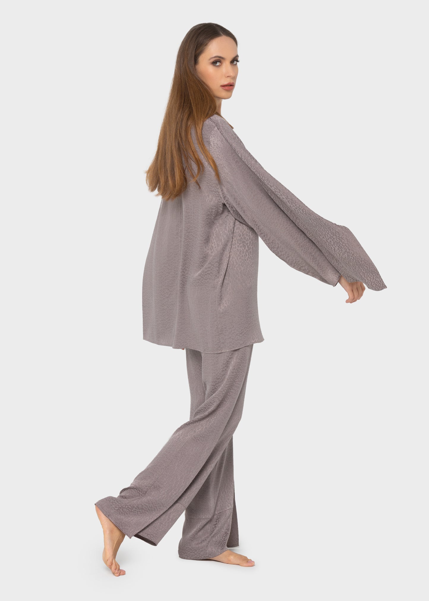 Woman wearing a gray long-sleeve lounge top with matching gray wide-leg lounge pants