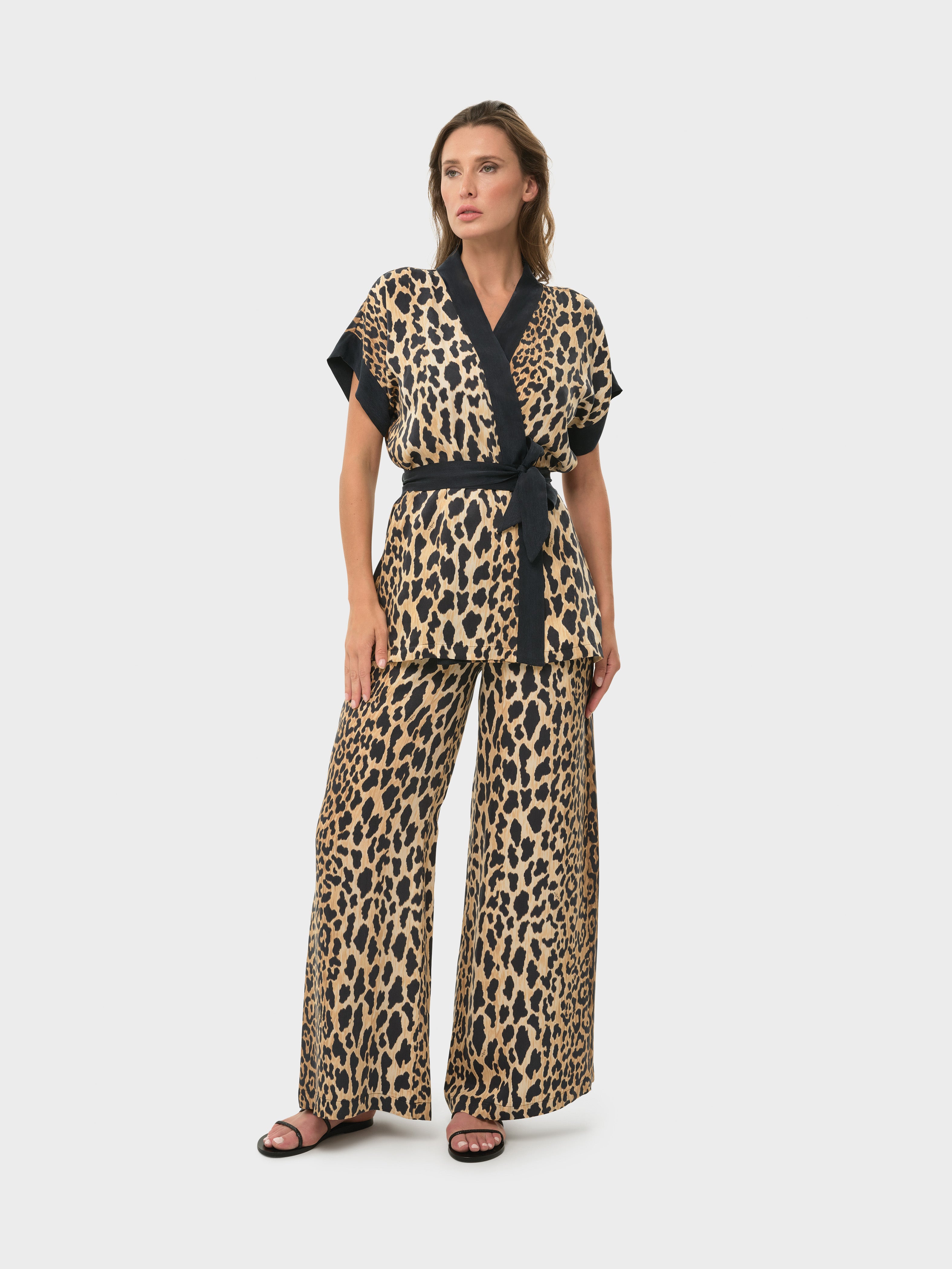 Model wearing Leo Mystique short sleeve wrap top and lounge pant matching set.