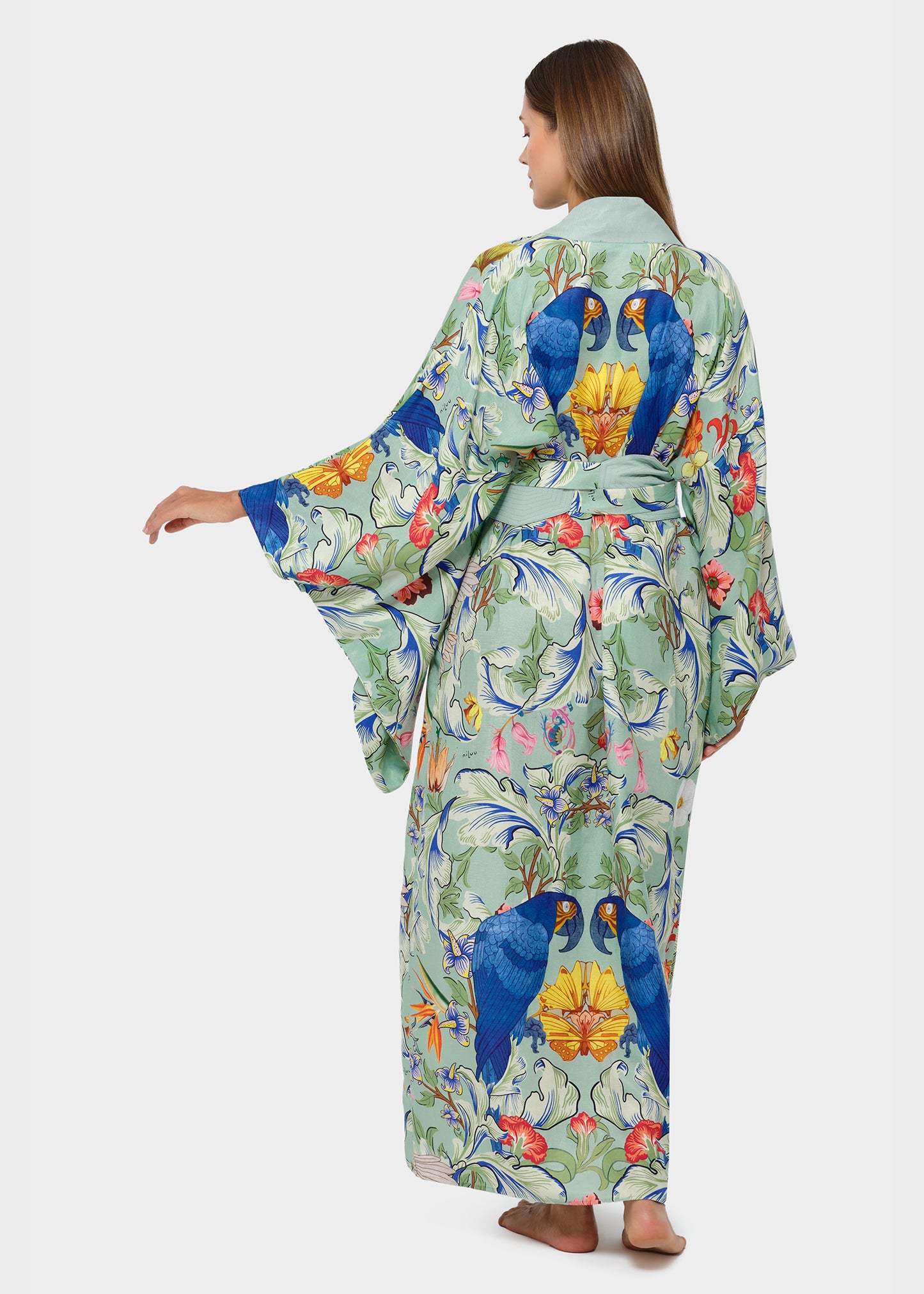 Model in green bird-print kimono robe with wide sleeves and tie belt, back view.