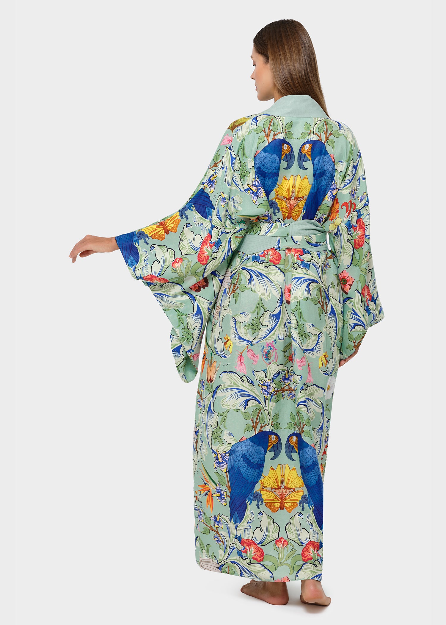 Model in green bird-print kimono robe with wide sleeves and tie belt, back view.
