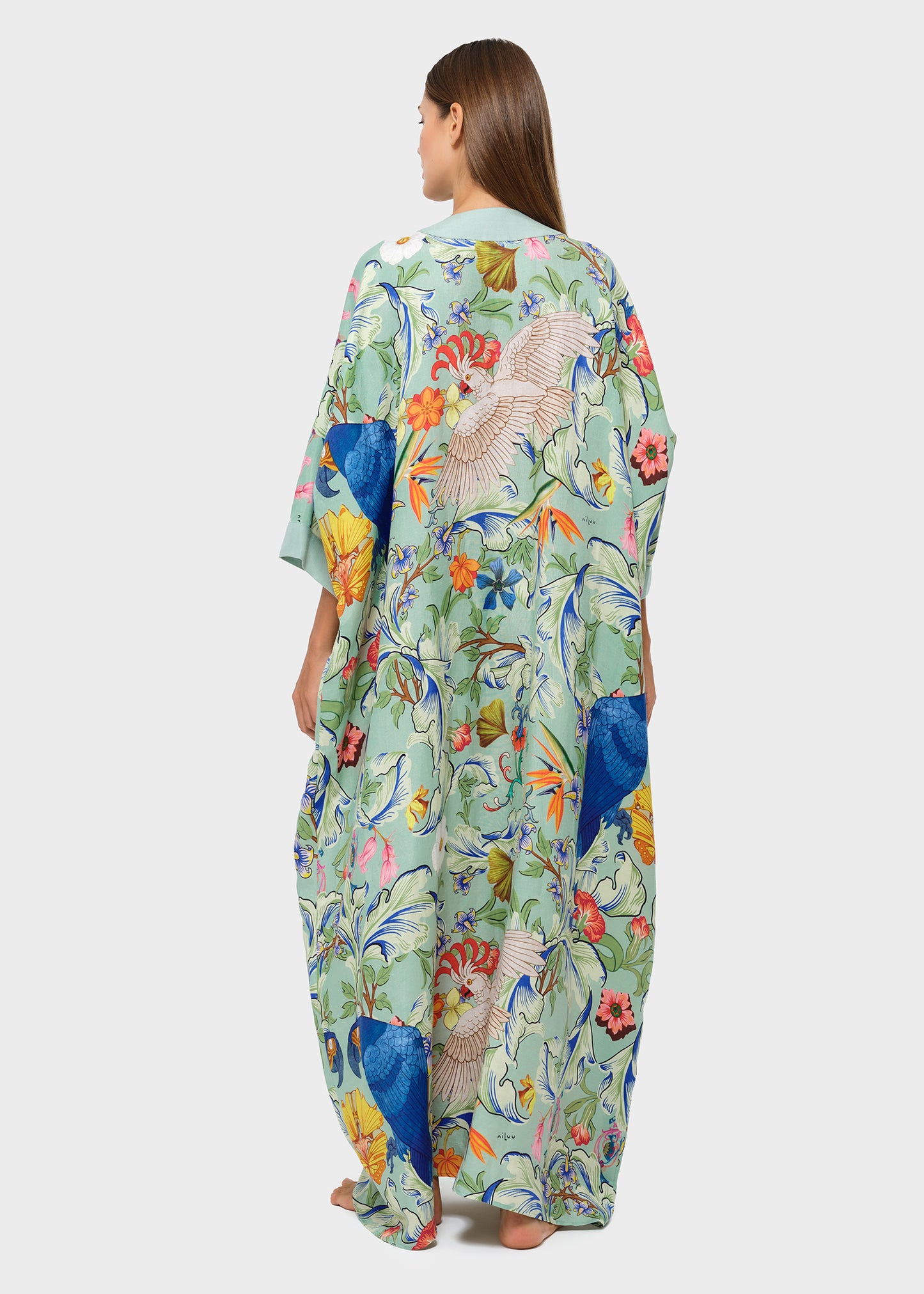 Back view of model wearing a green printed long robe with wide sleeves.