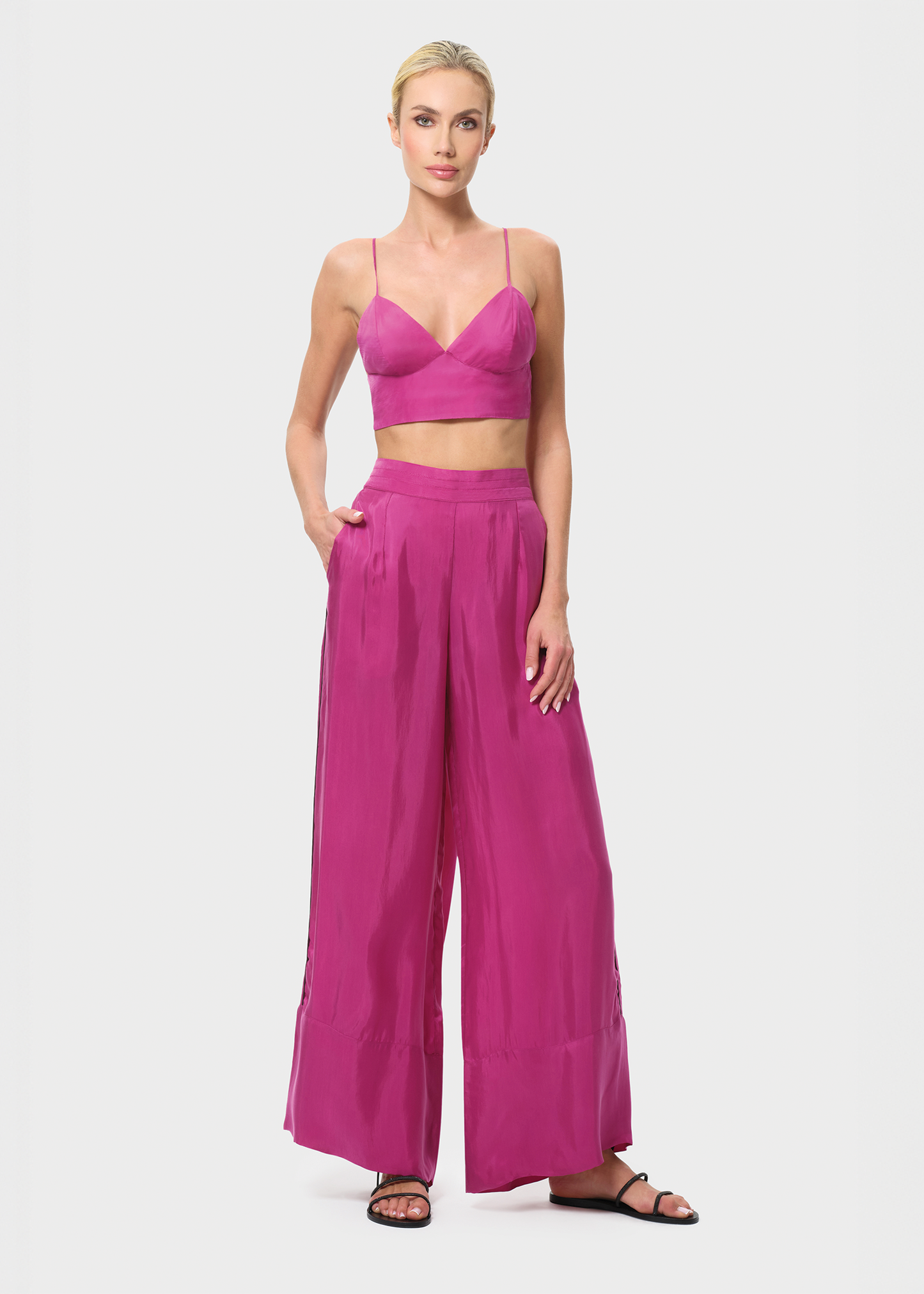 Woman wearing a pink outfit on a white background