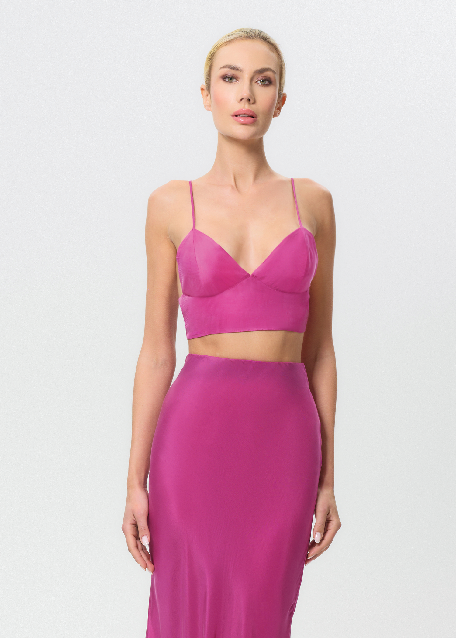 Woman wearing a pink outfit on a white background