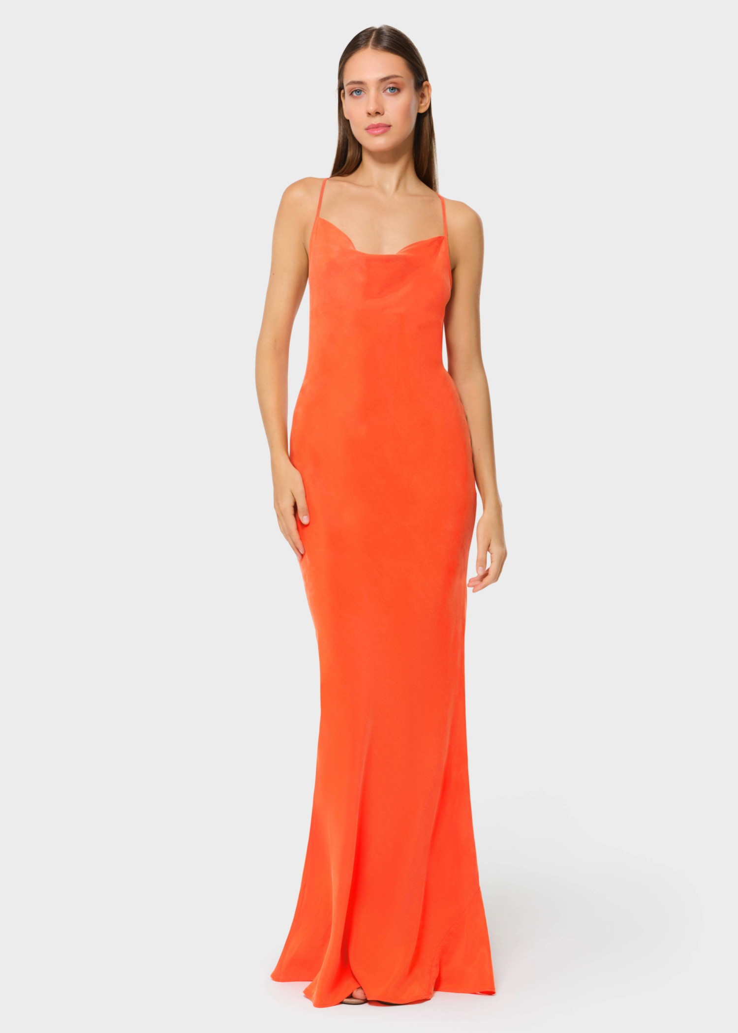Woman wearing bright orange vegan silk slip maxi dress, front view